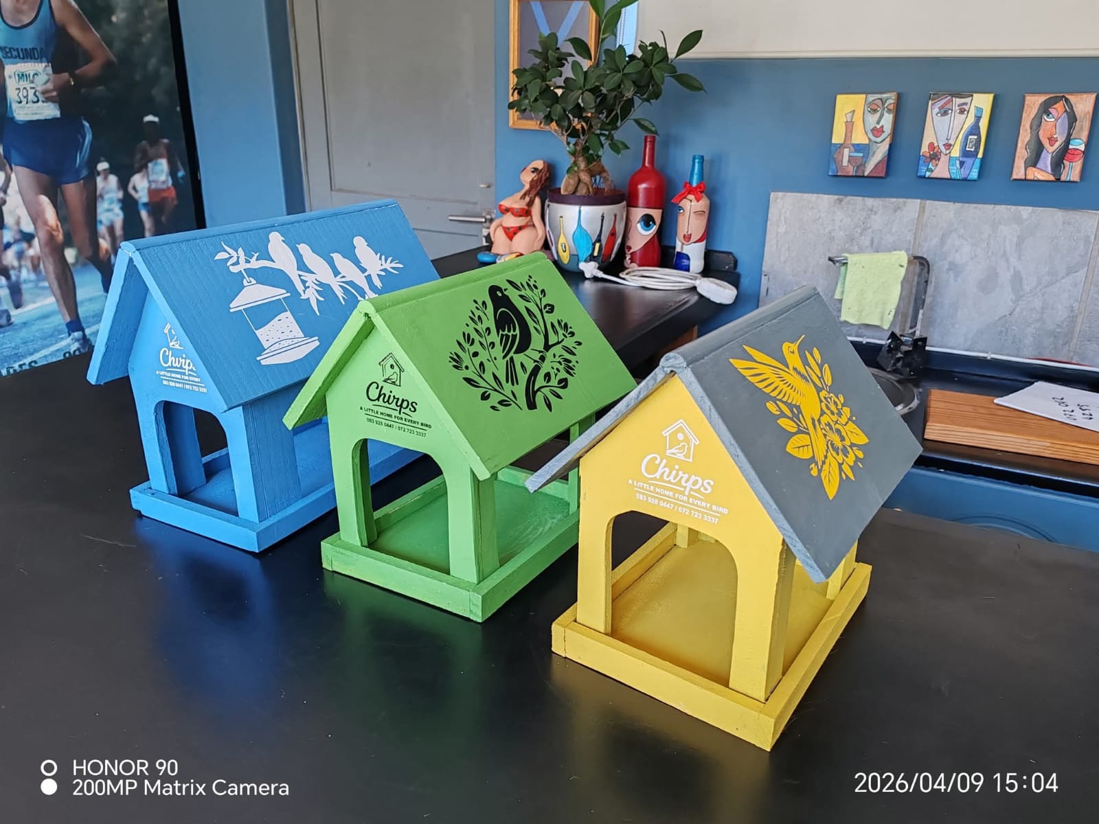 Printed wooden Chirps bird feeders in blue, green and yellow